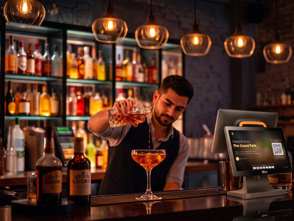 Bartender working an eatOS terminal at the rail